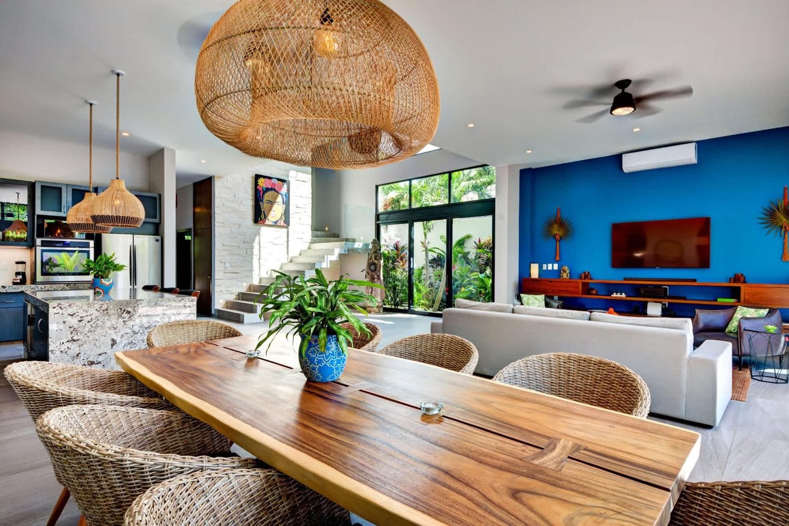 Live edge dining table under an oversized rattan pendant