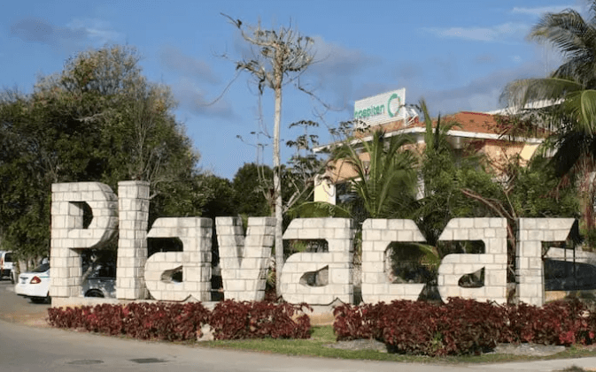 Playacar gated community entrance with tropical palms